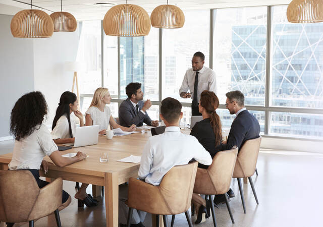 business people working together around a board table