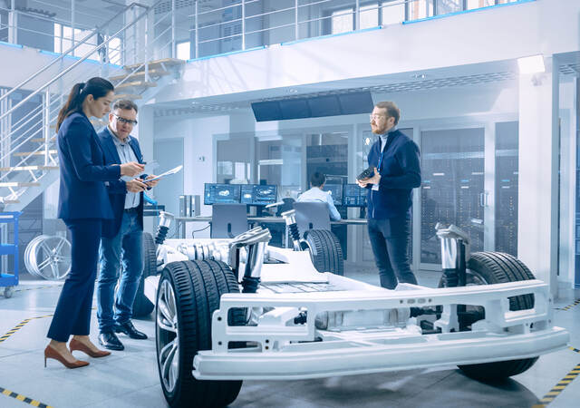 People working around an electric car