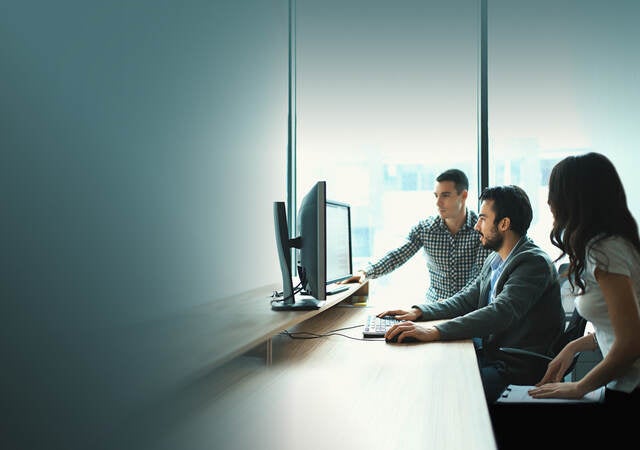 People looking at a monitor together