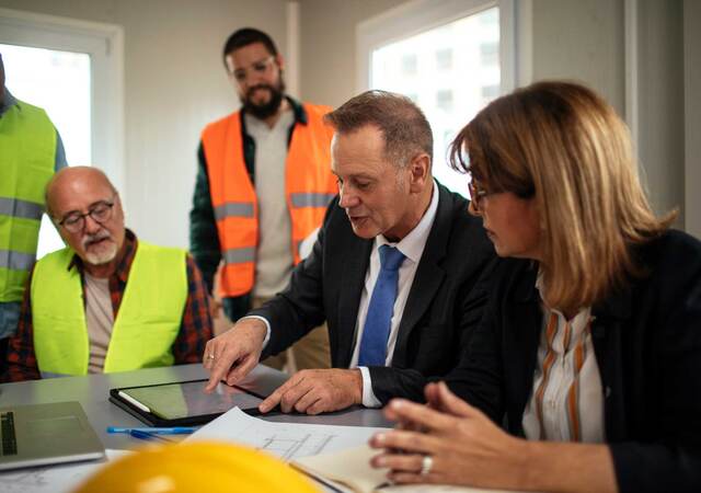 Board directors having a meeting with the team in the office at the construction site