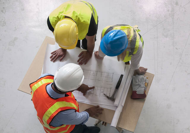 Contractors reviewing blueprints