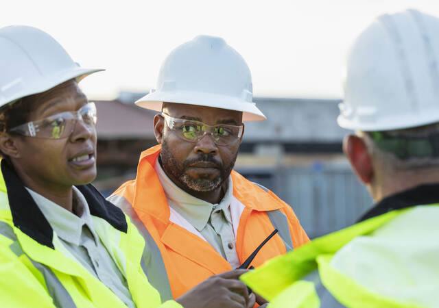 Three people discussing fire barrier management