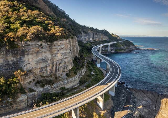 A winding costal road alongside a steep mountain