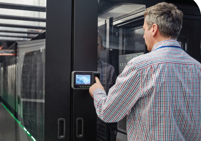 Person with wall-mounted touchscreen smart device