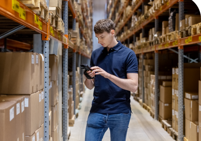 man with scanner in warehouse