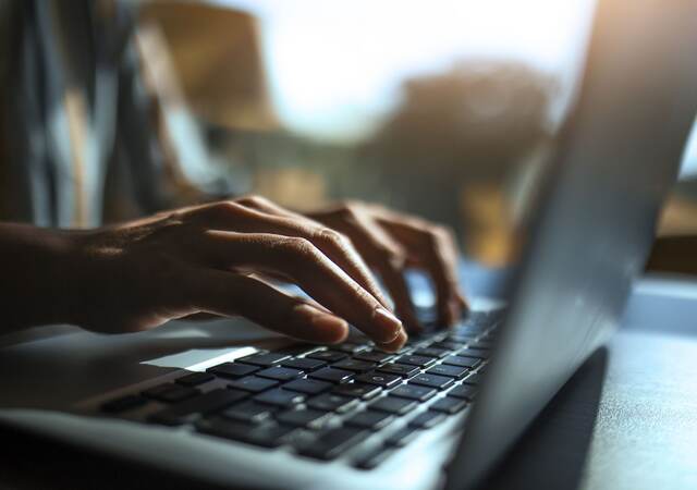 Man typing on laptop