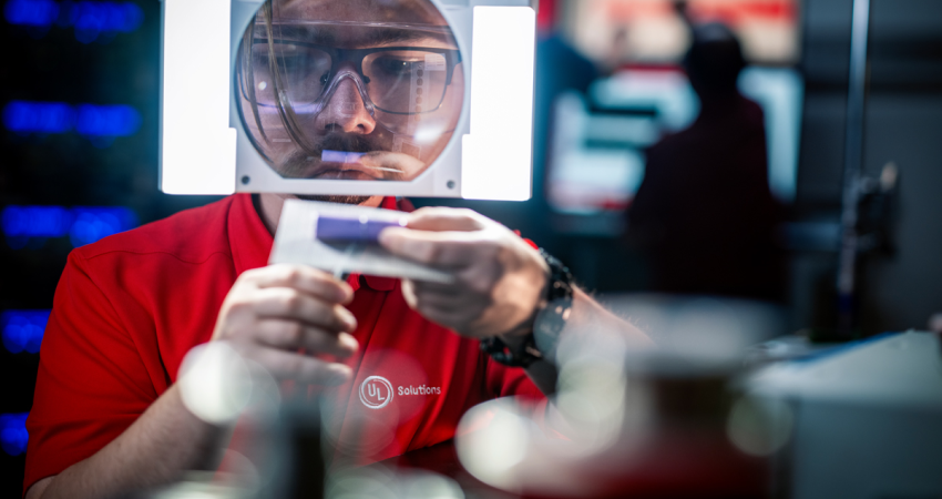 UL Solutions employee inspecting an object using an illuminate magnifier