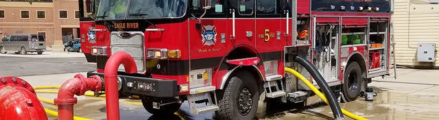 A parked fire truck receiving maintenance.