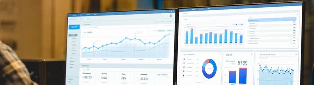 two monitors showing graphs and data