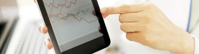 Doctor hands hold and show digital tablet pc to patient.