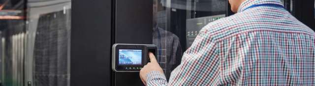 Person with wall-mounted touchscreen smart device