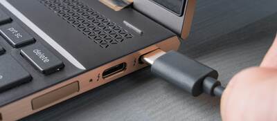 USB Type-C® grey cable being connected to a laptop.