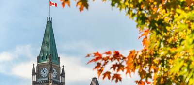 Peace Tower of the Canadian Parliament with autumn foliage in Ottawa