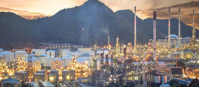 Oil refinery, aerial petrochemical storage tanks with refining industrial floor, oil refinery at night.