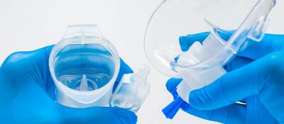 A young healthcare worker is preparing an asthma nebulizer.