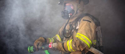 Firefighter ready to spray water