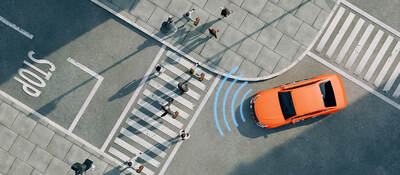 Ariel view of an orange car on a street