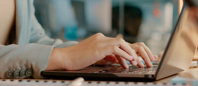 a person typing on a laptop