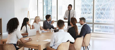 business people working together around a board table