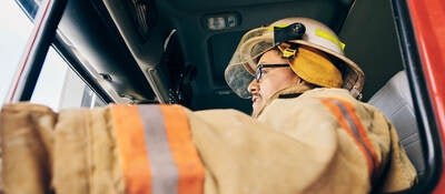 A firefighter in a fire truck