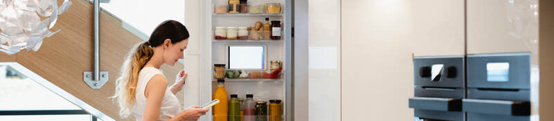 Woman looking into her fridge