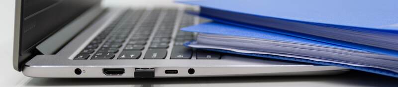 Folders and laptop on a desk.