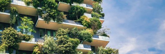 Exterior of a tall building with plants all over