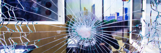 Unbroken bulletproof glass shown after it is shot.