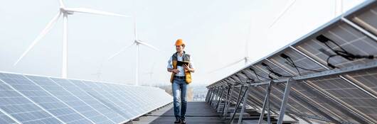 Engineer walking down a row of solar panels