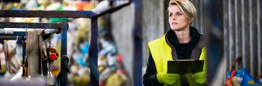 Woman worker on landfill, waste management and environmental concept.