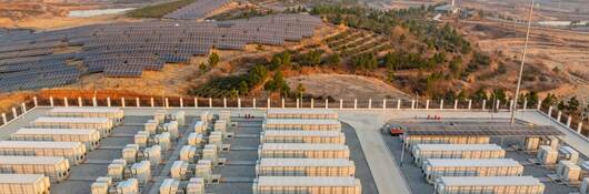 Overhead view of an energy power station next to a solar farm