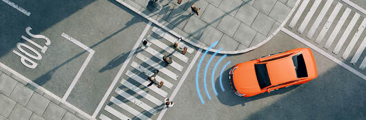 Ariel view of an orange car on a street