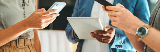 three people using different mobile devices