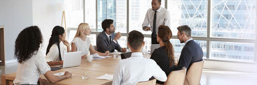 business people working together around a board table