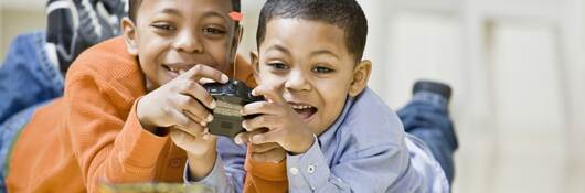 Two children playing with remote controlled car