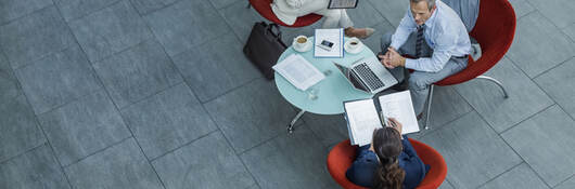 Overhead view of three people having an informal meeting