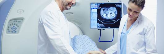 Doctors preparing patient for CT scan in hospital