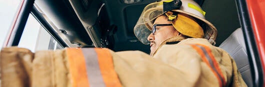 A firefighter in a fire truck