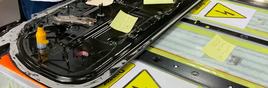 Close-up of a mechanic repairing an electric car battery