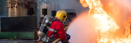 Firefighters Extinguishing Blaze in Industrial Area