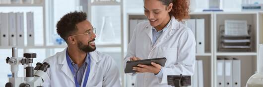 Shot of two young scientists working together in a lab