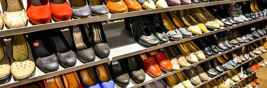 Variety of shoes for display in shop on shelf