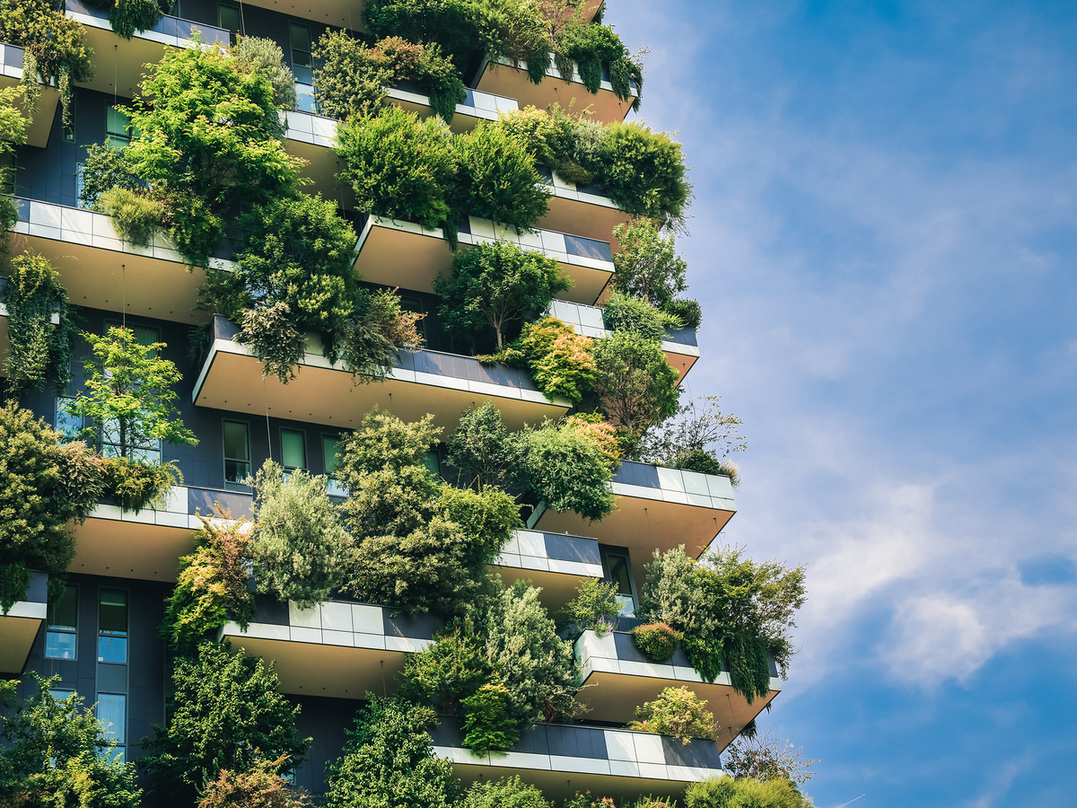 Exterior of a tall building with plants all over