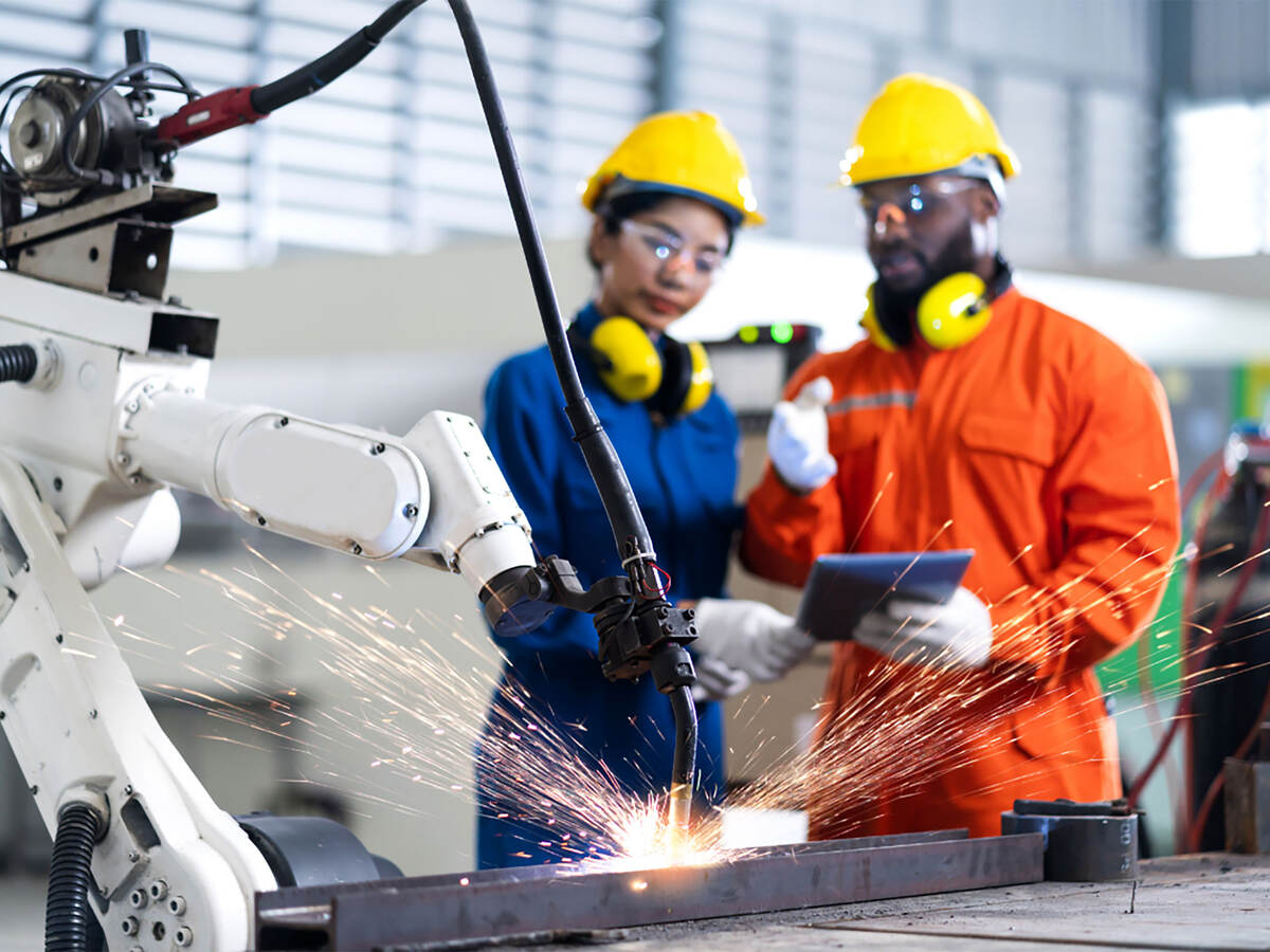 People wearing PPE and working with machinery