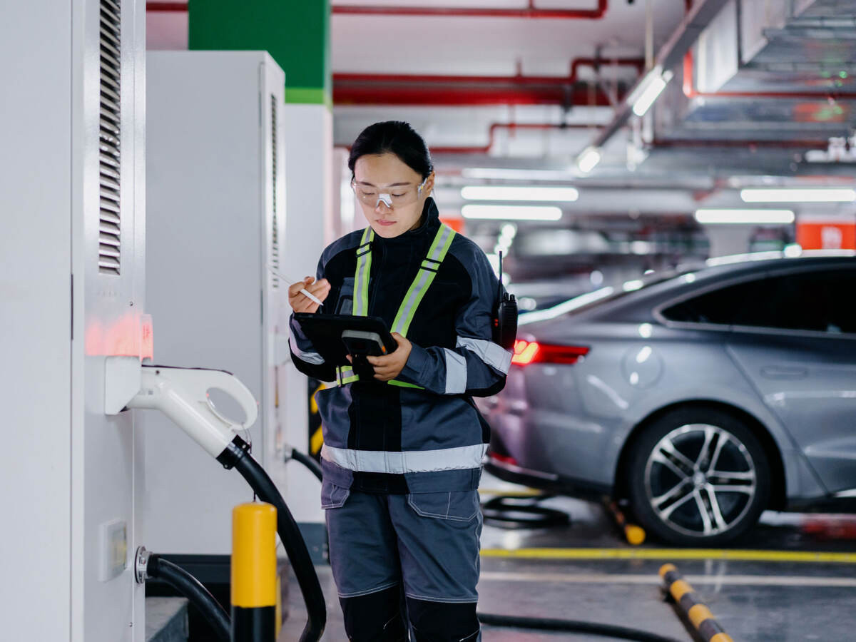 A person inspecting a charging station