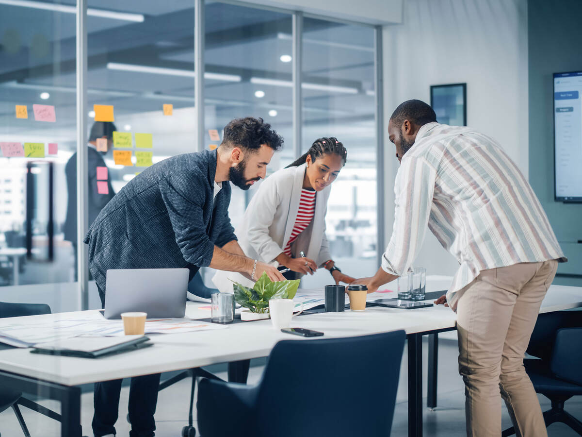 A diverse team collaborates over a conference table