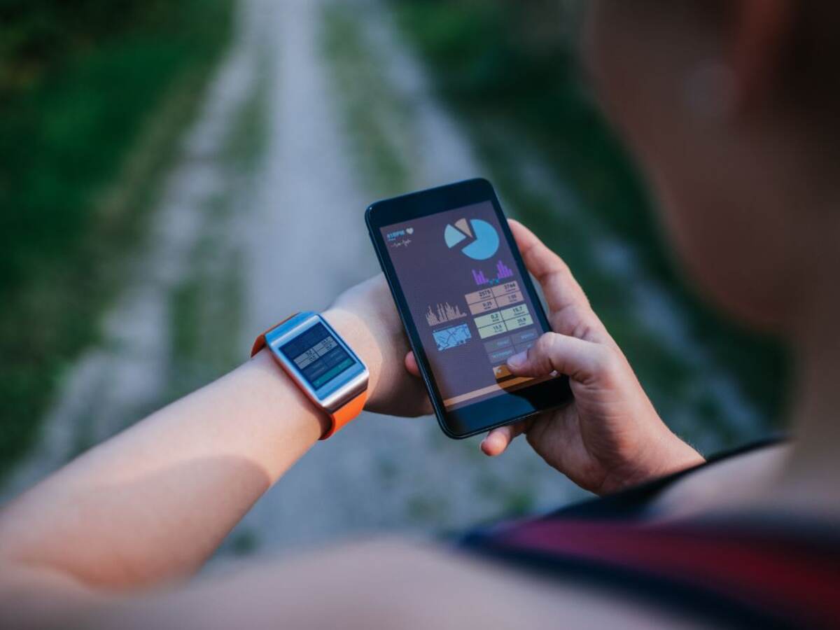 Man using smart phone and smart watch outside