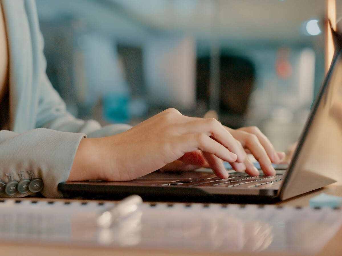 a person typing on a laptop