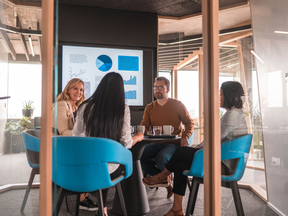 Group of colleagues discussing metrics during an informal meeting