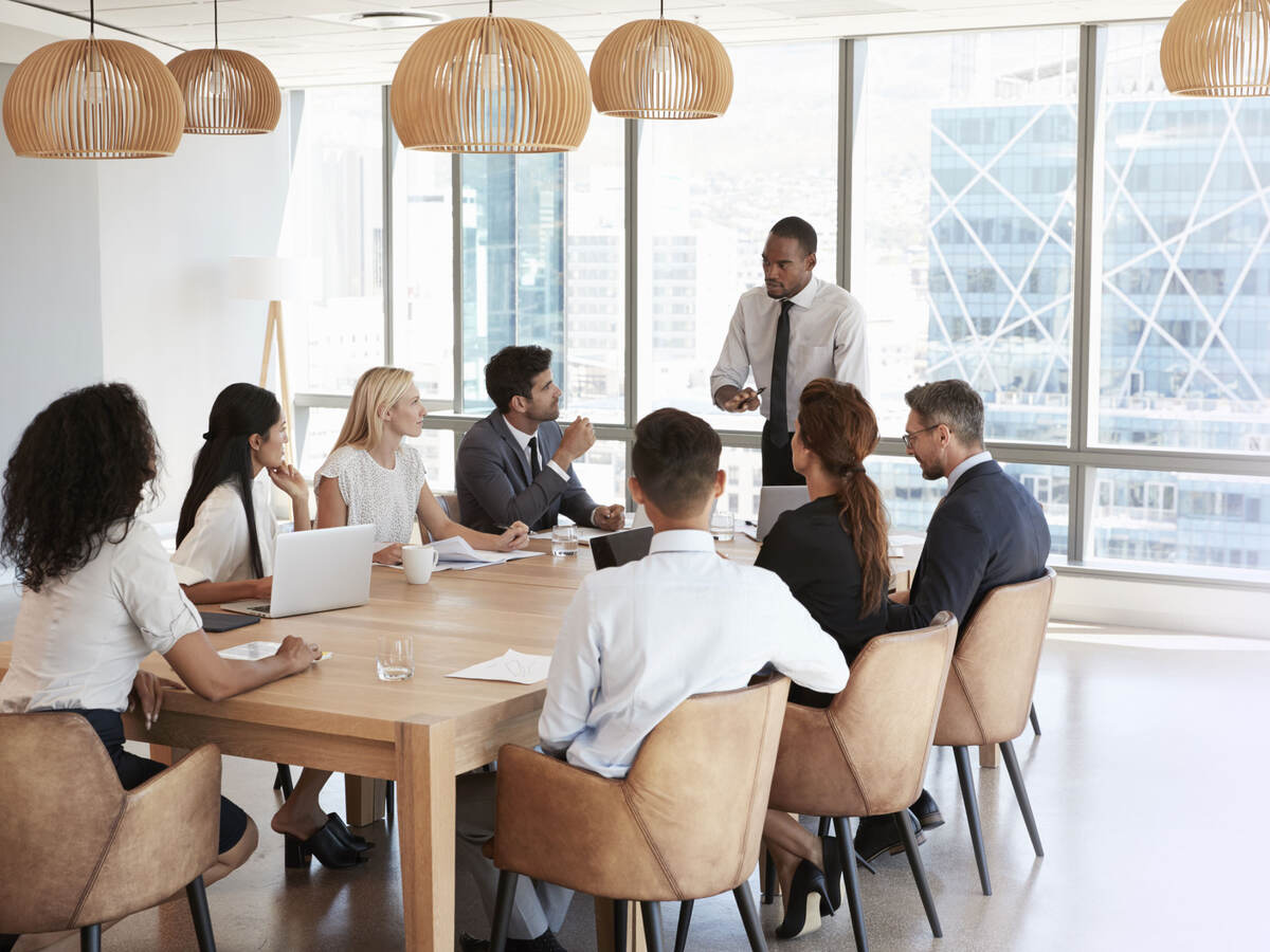 business people working together around a board table